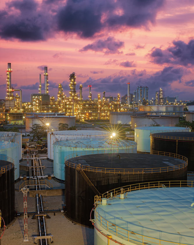 Tangshan petrochemical refinery factory project at sunset, crude oil storage tanks and distillation tower explosion-proof lighting application